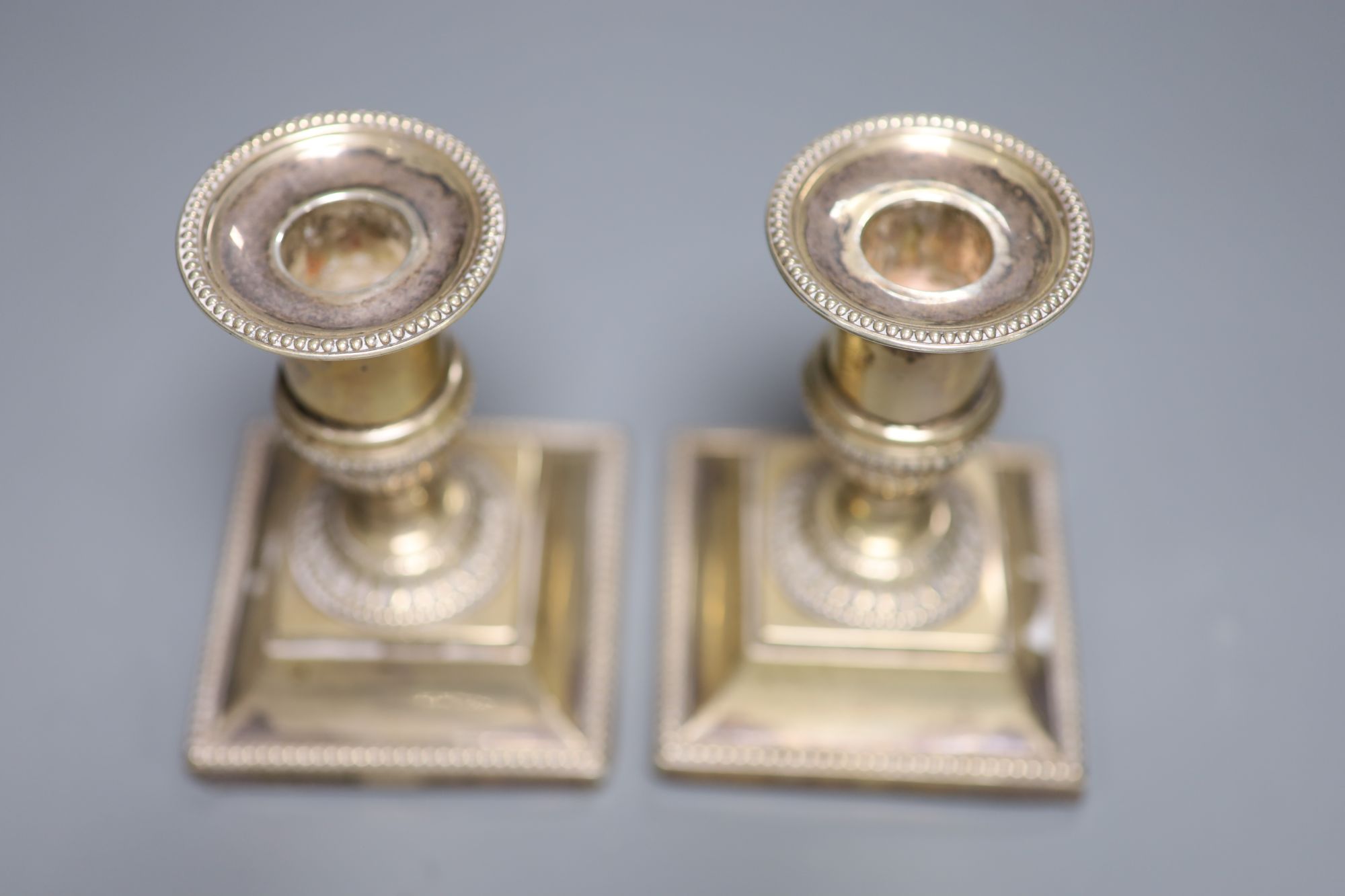 A pair of late Victorian silver dwarf candlesticks, Josiah Williams & Co, London, 1892, 11.1cm, weighted.